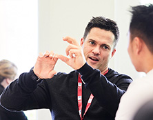 Man having a conversation with another man in a classroom