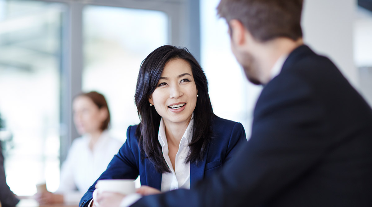 Man and women in office setting negotiating